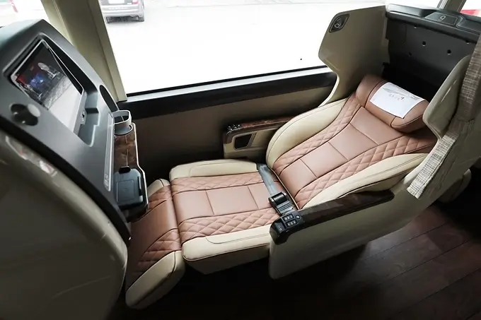 Luxurious reclining leather seat inside a Korean premium express bus with a personal entertainment screen